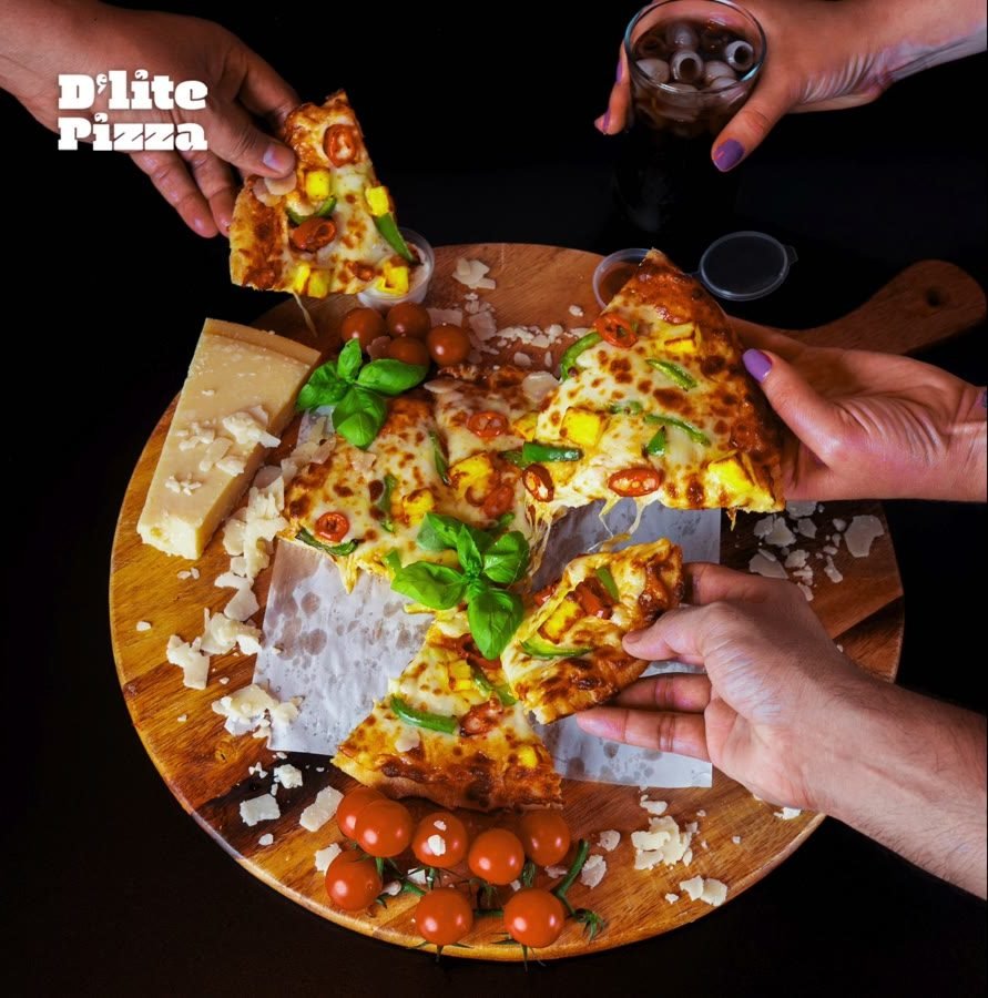 Hands reaching for slices of pizza on a wooden board