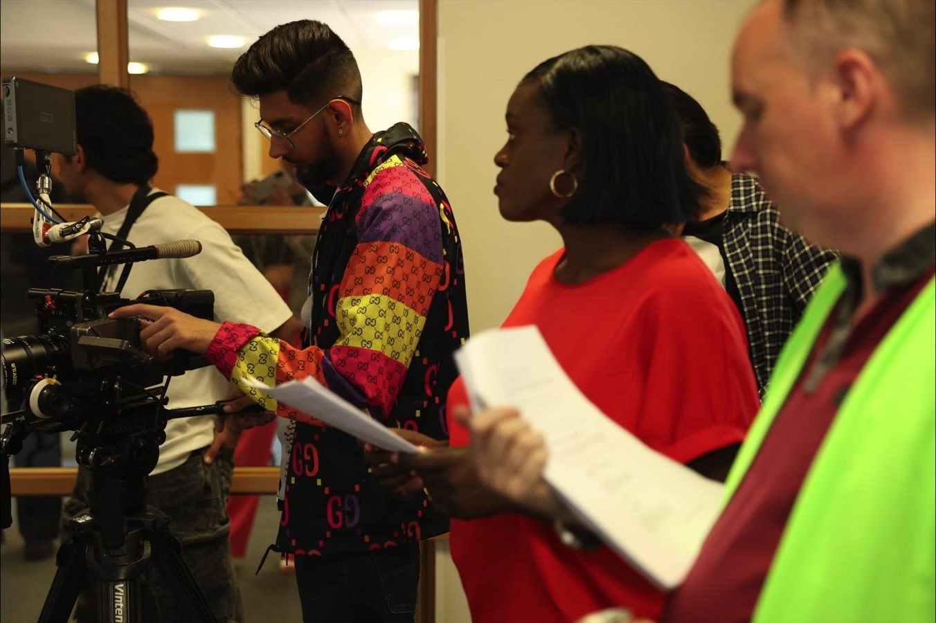 Director and cast going through the script on set