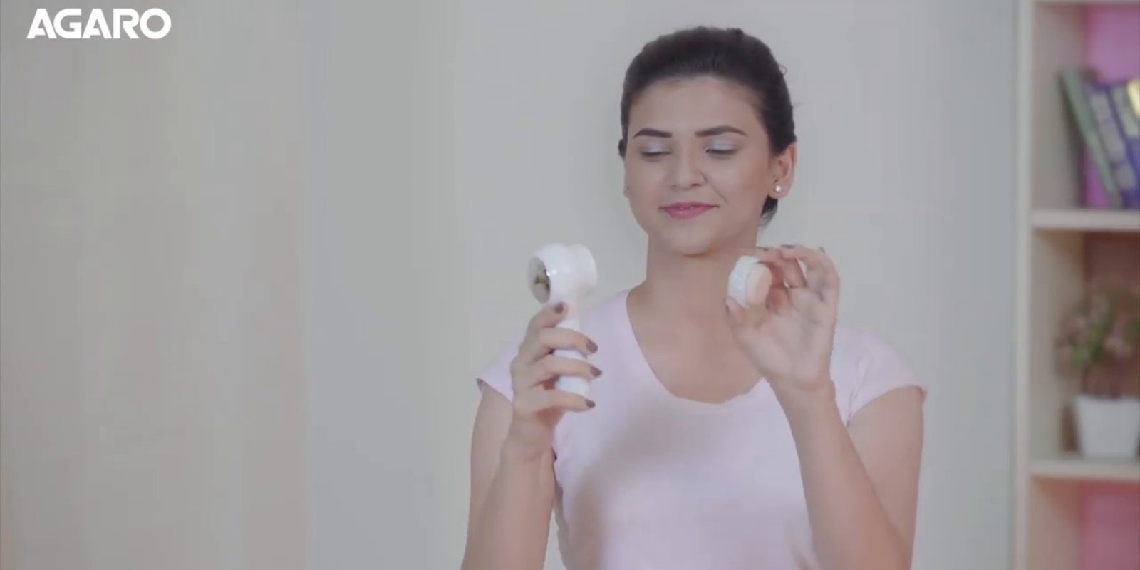 Woman smiling with an Agaro beauty device